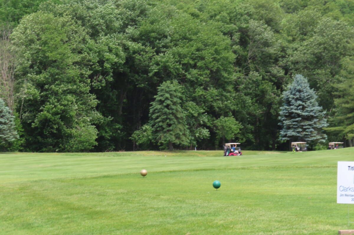 Golfers and carts move out as the tournament gets underway.