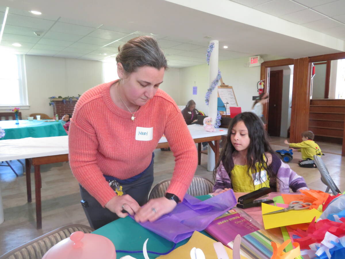 Mary Andres, left, shows her daughter, Brianna, 7, how to make a craft.