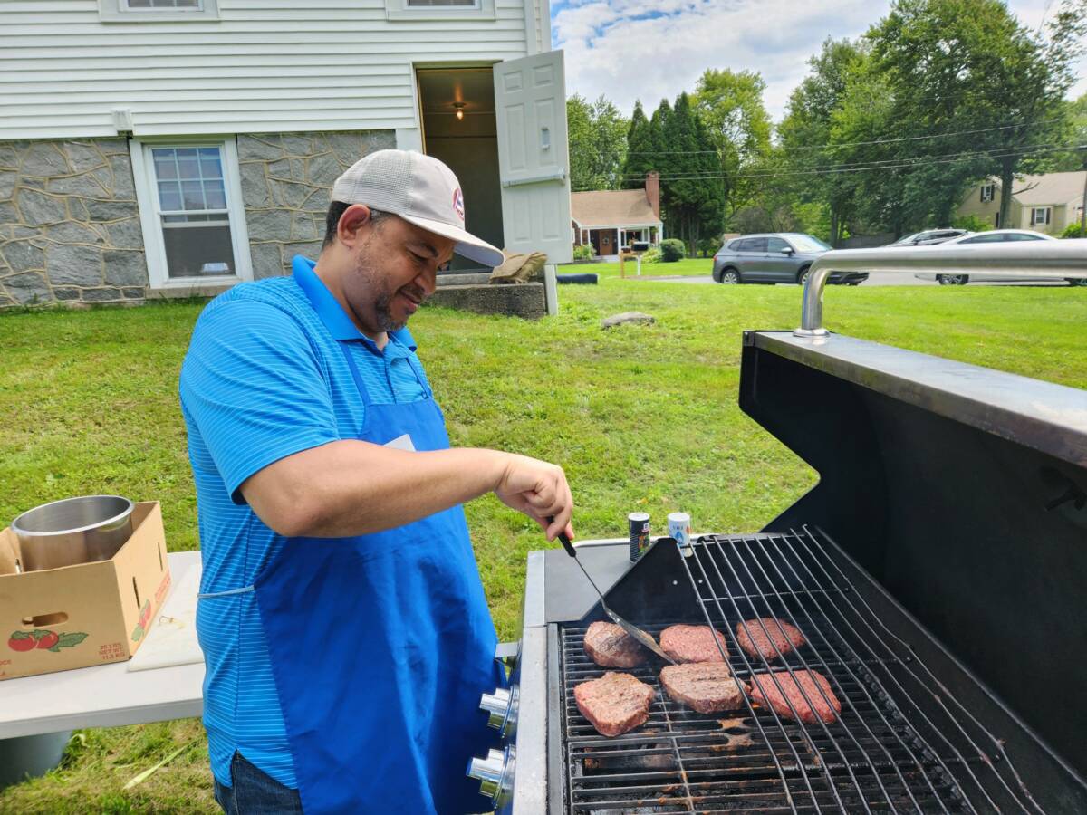 Pedro Soriano grills burgers.
